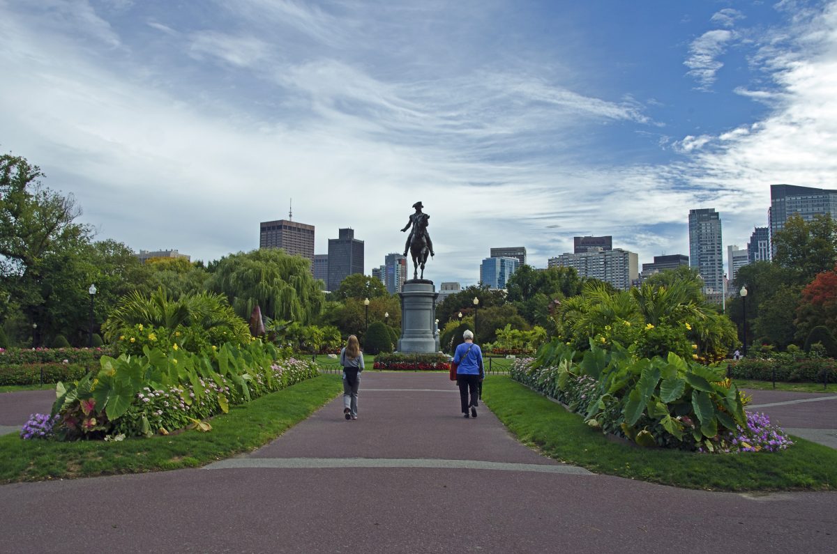 Two people walk in a Boston park.